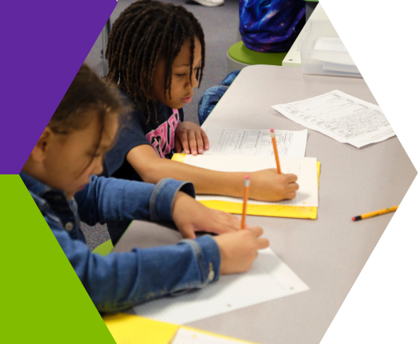 Club members writing and drawing together at a table